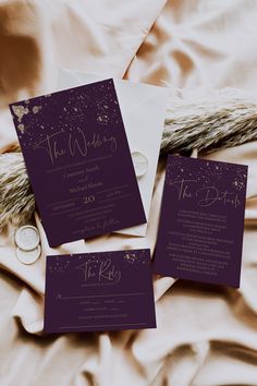 the wedding stationery is laid out on the bed