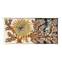 an embroidered wall hanging with birds and trees on it's sides, in the shape of a sun