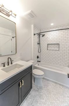 a bathroom with a toilet, sink and bathtub