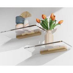 two glass shelves with vases and flowers on them