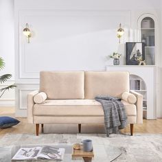 a living room with a couch, coffee table and bookshelf