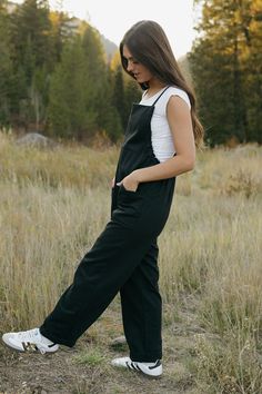 Introducing our Callum Overalls in black! Featuring a relaxed fit, adjustable straps, and front pockets, these overalls are both stylish and functional. The raw hem detail along the sides and back add an edgy touch, while the cinched sides offer even more detail. Perfect for your everyday look! *Relaxed fit* Material Content: 60% Cotton // 40% Polyester Material Pattern: Solid Kirsten is 5'4" wearing a small Model measurements: Kirsten: Height: 5'4" // Chest: 32" // Waist: 24" // Hips: 27" Amand Black Cotton Jumpsuits And Rompers With Adjustable Straps, Casual Black Jumpsuits And Rompers With Adjustable Straps, Black Overall Jumpsuit With Adjustable Straps, Black Overalls With Adjustable Straps, Black Jumpsuit With Adjustable Straps, Black Overalls With Suspenders, Everyday Bib Front Overalls With Pockets, Utility Overalls With Adjustable Straps For Everyday, Everyday Utility Overalls With Adjustable Straps