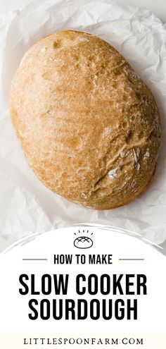 a round loaf of slow cooker sourdough sitting on top of white paper