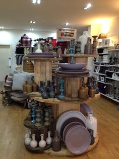 there are many plates and bowls on display in the store