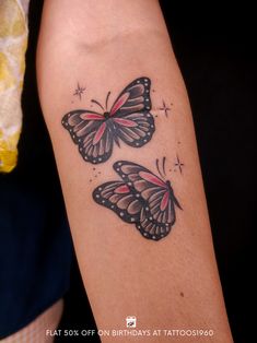 two butterflies tattoo on the arm