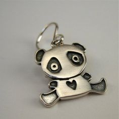 Sweet solid sterling silver Panda earrings to last a lifetime!  They are 1/2 of an inch tall and made completely from sterling silver with solid sterling French ear wires. Adorable!To see all my sterling silver charm earrings go here:https://www.etsy.com/shop/marmar?ref=hdr_shop_menu&section_id=5064601For the large matching necklace:http://www.etsy.com/listing/94186350/panda-bearFor the small matching necklace:http://www.etsy.com/listing/91509033/baby-panda-necklaceFor the mother-daughter se Handmade Sterling Silver Dangle Charms, Minimalist Sterling Silver Dangle Charms, Cute Sterling Silver Earrings With Ear Wire, Cute Silver Dangle Charms, Cute Sterling Silver Dangle Earrings, Silver Charm Earrings For Everyday, Pendant Earrings With Charms For Gift, Personalized Sterling Silver Earrings For Everyday, Silver Charm Earrings For Anniversary