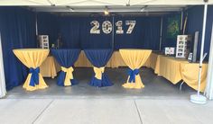 several tables covered in yellow and blue cloths with the number 705 on them