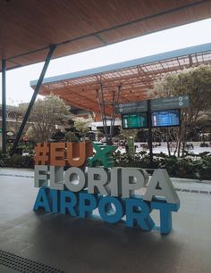 an airport sign with the words florida airport in blue and orange letters on it's side