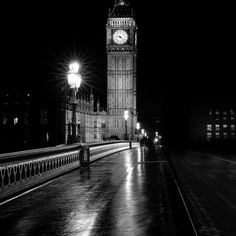 the big ben clock tower towering over the city of london in the rain at night