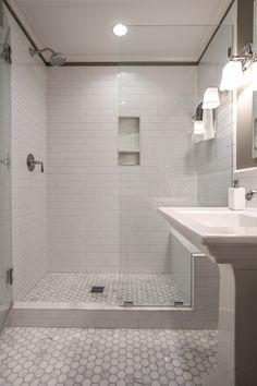 a bathroom with a walk in shower next to a sink