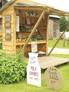 an outdoor market with fresh eggs and farm fresh milks on the outside, in front of a wooden shed