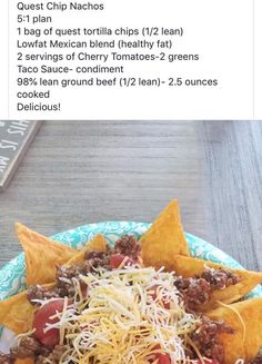 a plate filled with taco salad and tortilla chips on top of it