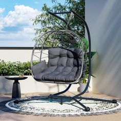 a swing chair sitting on top of a patio