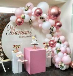 balloons and cake on display at a bridal show