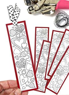 someone is cutting out valentine's day coloring pages with scissors and paper cutters