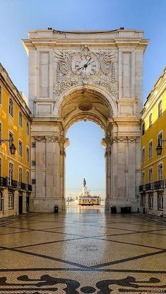 an arch in the middle of a building with a clock on it's side