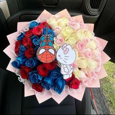 a bouquet of flowers in the back seat of a car with hello kitty on it