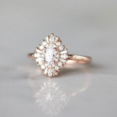 a close up of a diamond ring on a white surface with the light shining through it