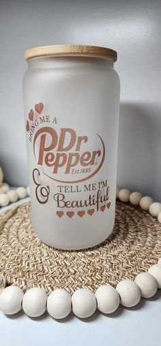 a white jar sitting on top of a table next to some beads and a bead necklace