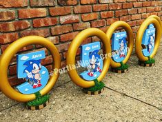 three wooden signs with sonic the hedgehogs on them in front of a brick wall