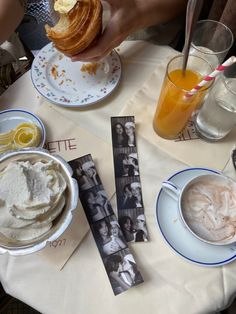 a table topped with plates and cups filled with food