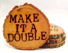 two pieces of wood with words on them that read make it a double and stacked logs