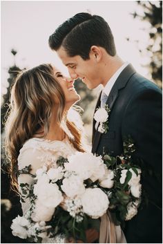 a bride and groom smile at each other