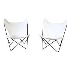 two white chairs sitting next to each other