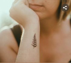 a woman with a small tattoo on her arm