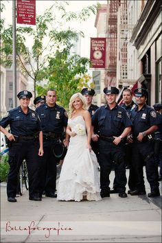 a bride and groom standing in front of police officers