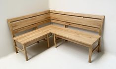 the corner bench is made out of wood and has two benches on each one side