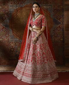 a woman in a red and white lehenga