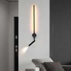 a black and white photo of a modern light fixture on the wall in a living room