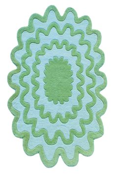 a blue and green rug with an intricate design on it's center piece, in the shape of a flower