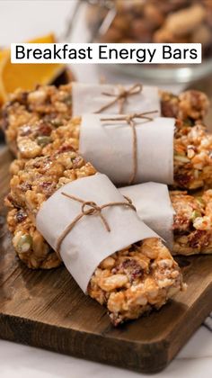 breakfast energy bars on a cutting board with oranges in the background and text overlay that reads, breakfast energy bars