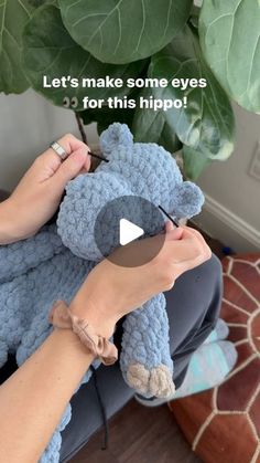 someone is crocheting a blue teddy bear on the couch with text that reads let's make some eyes for this hippo