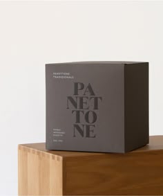 a box sitting on top of a wooden table next to a white wall with the words pa net to ne