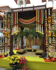 an outdoor decorated with flowers and greenery