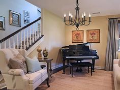 a living room filled with furniture and a grand piano