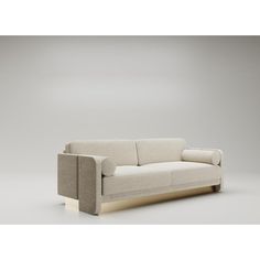 a white couch sitting on top of a gray floor