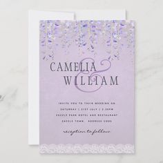 the purple and silver wedding card is displayed on a marble surface