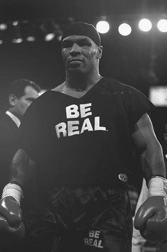 a black and white photo of a man wearing boxing gloves