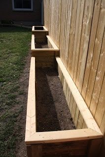 a wooden bench sitting in the middle of a yard