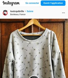 a sweater with dandelions printed on it