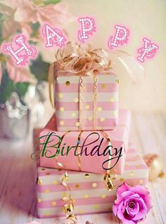 a stack of pink and white presents with the words happy birthday