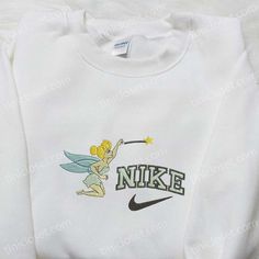 Introducing the magical collaboration between Nike and Tinkerbell! Our Nike x Tinkerbell Cartoon Embroidered Sweatshirt combines the enchanting world of White Disney Cotton Sweatshirt, Disney Crew Neck Sweatshirt With Embroidered Logo, Disney Cotton Sweatshirt With Embroidered Graphics, Disney Style Cotton Hoodie For Disney Fan Events, Disney Embroidered Long Sleeve Sweatshirt, Tinkerbell Cartoon, Nike Cartoon, Best Birthday Gift Ideas, Disney Character Shirts