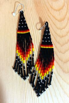 These earrings symbolize sunset and the onset of night.  These are an original Native American Bling design.  The earrings are made with black heishi syle beads, Miyuki 11/0 beads in silver, yellow, orange, red and dark red colors.  The length of the beaded portion is approximately 4 inches.  The earring hooks are made of sterling silver.   These earrings are made to order so please allow 1-2 weeks for completion (does not include shipping time). Orange Dangle Beaded Earrings With Black Beads, Orange And Black Beads Dangle Earrings, Orange Dangle Earrings With Black Beads, Orange Dangle Jewelry With Black Beads, Black Earrings With Tiny Round Beads, Landscape Earrings, Bling Design, Jaune Orange, Beaded Earrings Patterns