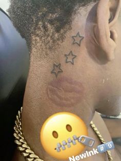 the back of a woman's neck with stars on it and a smiley face