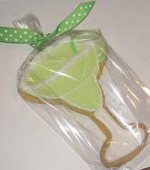 a cookie shaped like a green apple in a plastic bag