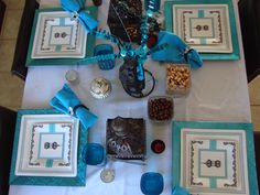 the table is set up with blue and white plates, napkins, and decorations